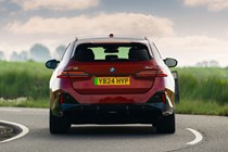 BMW i5 Touring: M60 model, rear cornering, red paint
