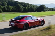 Porsche Panamera GTS: rear three quarter driving, red paint, spoiler extended