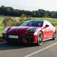 Porsche Panamera GTS: front three quarter driving, red paint, sunlight