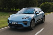 Porsche Macan Electric (2024) review: front three quarter driving, high angle, blue paint