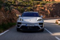 Porsche Macan (2024) review: front driving, mountain road, silver paint