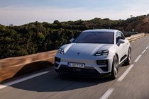 Porsche Macan (2024) review: front three quarter driving, forest in the background, silver paint