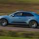 Porsche Macan Electric (2024) review: side view driving, blue paint, fields in background