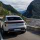 Porsche Macan (2024) review: rear three quarter driving, mountain road, silver paint