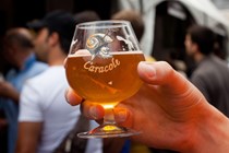 Hand holding glass of beer - driving in Belgium