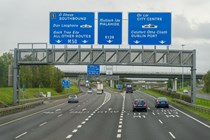 Motorway gantry with signs in Ireland - Driving in Ireland