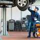 Mechanic servicing car on lift - What is depreciation