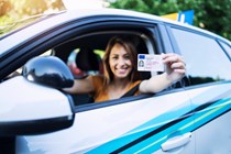 Woman holding driving license - How to renew driving license