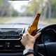 Drunk driver holding beer bottle - How to report dangerous driving