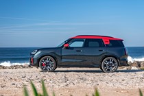 MINI Countryman JCW (2024) review: side view three quarter static, black and red paint