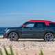MINI Countryman JCW (2024) review: side view three quarter static, black and red paint