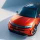 Vauxhall Frontera (2024): front three quarter static, high angle, studio shoot, orange paint