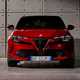 Alfa Romeo Milano: front static, studio shoot, bright lighting, red paint