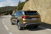 Skoda Kodiaq (2024) review: rear three quarter driving, gold paint, country road