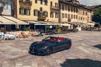 Maserati GranCabrio Trofeo review: front three quarter driving through a town, black paint