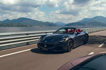 Maserati GranCabrio Trofeo review: front three quarter driving over a bridge, black paint
