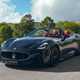 Maserati GranCabrio Trofeo review: front three quarter driving, sun, black paint