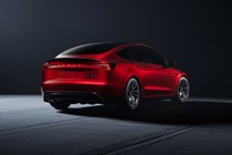 Tesla Model 3 Performance: rear three quarter static, low angle, red paint, studio shoot