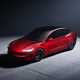 Tesla Model 3 Performance: front three quarter static, high angle, red paint, studio shoot