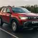 Dacia Duster review - front, red, driving