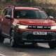 Dacia Duster review - front, red, driving round corner