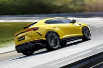Lamborghini Urus driving rear, yellow
