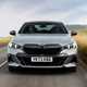 BMW 5 Series review: front driving, close up, low angle, matte grey paint