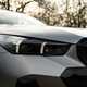 BMW 5 Series review: LED headlight detail shot, matte grey paint