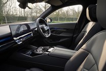 BMW 5 Series review: dashboard and infotainment system, from passenger seat, black leather upholstery