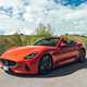 Maserati GranCabrio Folgore review: front three quarter driving through brushland, orange paint