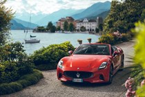 Maserati GranCabrio Folgore review: front three quarter static, lake in background, orange paint