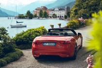 Maserati GranCabrio Folgore review: rear three quarter static, lake in background, orange paint