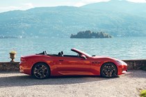 Maserati GranCabrio Folgore review: side view static, lake in background, orange paint