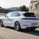 Porsche Cayenne review - 2023 facelift - Turbo E-Hybrid, white, rear, driving on circuit