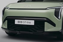 Kia EV3 (2024) reveal: front detail shot of grille and headlights, green paint, studio shoot