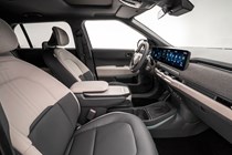Kia EV3 (2024) reveal: dashboard and infotainment system from passenger side, black and cream upholstery