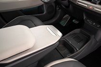 Kia EV3 (2024) reveal: sliding centre console tray table, retracted, black and cream upholstery
