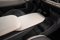 Kia EV3 (2024) reveal: sliding centre console tray table, extended, black and cream upholstery