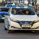 Autonomous vehicles: Nissan Leaf prototype, front three quarter driving, white paint