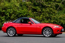 A red Mazda MX-5 Mk3 with black hardtop