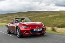 Mazda MX-5 Mk4 review - front view, red, roof down, driving on road