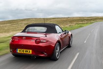 Mazda MX-5 Mk4 review - rear view, red, roof up, on road, driving