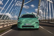 Skoda Elroq prototype: front driving, over a bridge, green camo wrap