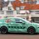 Skoda Elroq prototype: side view driving, in a city, green camo wrap