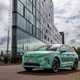 Skoda Elroq prototype: front three quarter static, green camo wrap, building in background