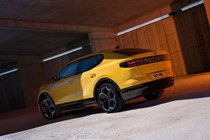 Ford Capri (2024) launch: rear three quarter static, studio shoot, yellow paint