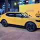 Ford Capri (2024) launch: front three quarter static, yellow paint, at launch event