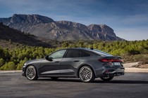 Audi A5 Sportback (2024): rear three quarter static, grey paint