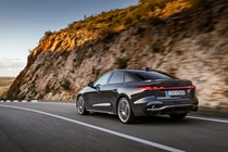 Audi A5 Sportback (2024): rear three quarter driving, grey paint