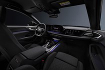 Audi A5 Sportback (2024): dashboard, front seats and infotainment system, black fabric upholstery